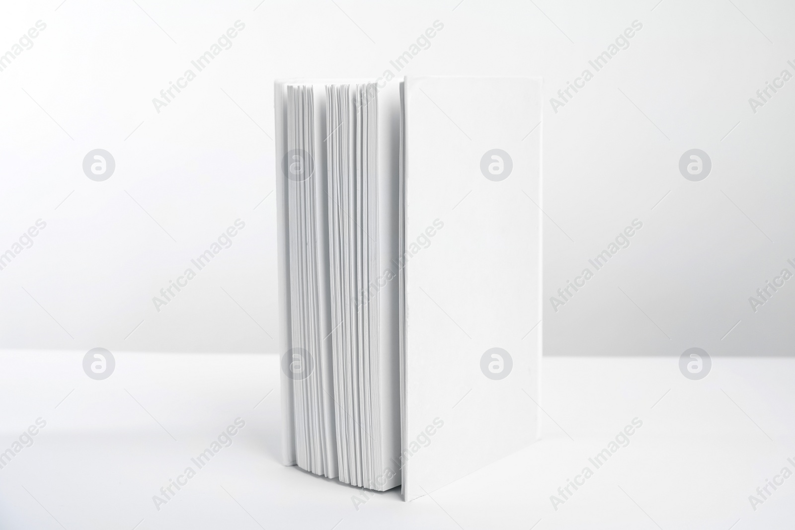 Photo of Book with blank cover on white background