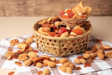 Mixed dried fruits and nuts on beige background