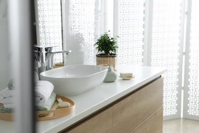 Modern bathroom interior with stylish mirror and vessel sink