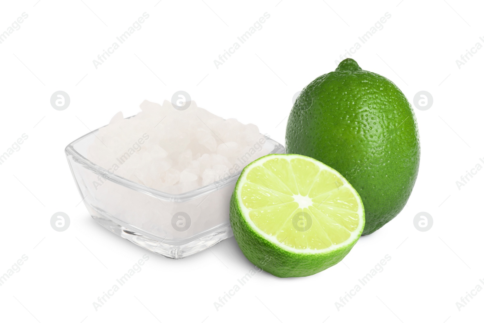 Image of Limes and salt isolated on white. Margarita cocktail ingredients