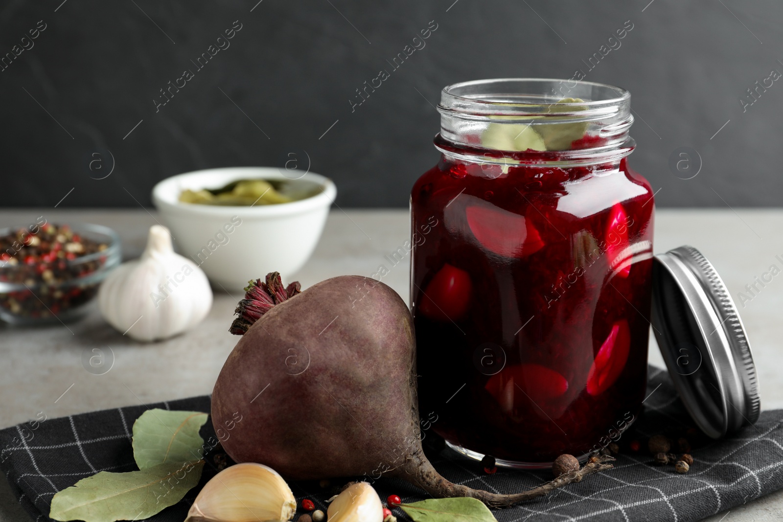 Photo of Pickled beets in glass jar on light table