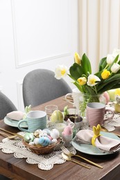 Festive table setting with beautiful flowers. Easter celebration