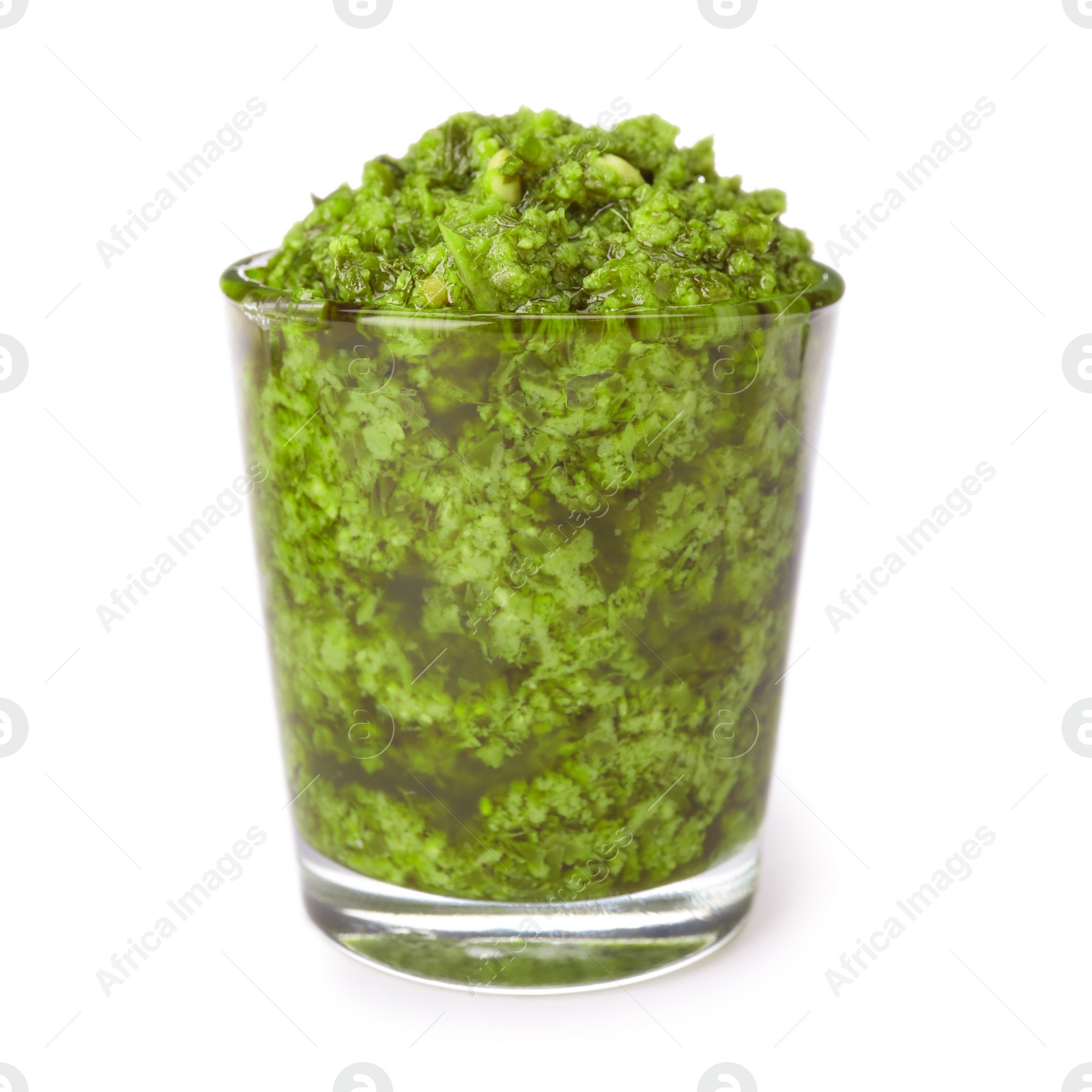 Photo of Glass of tasty pesto sauce isolated on white