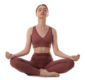 Beautiful young woman meditating on white background