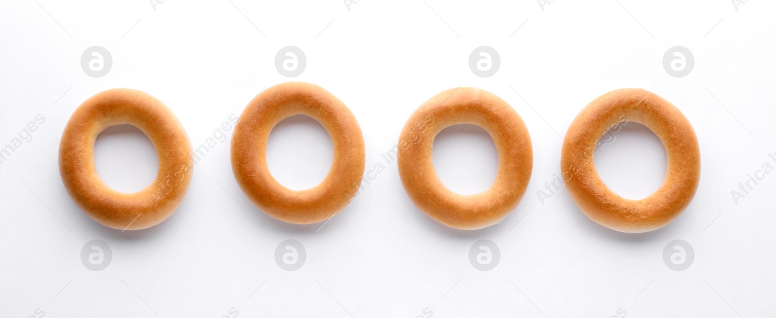 Photo of Tasty dry bagels (sushki) on white background, top view