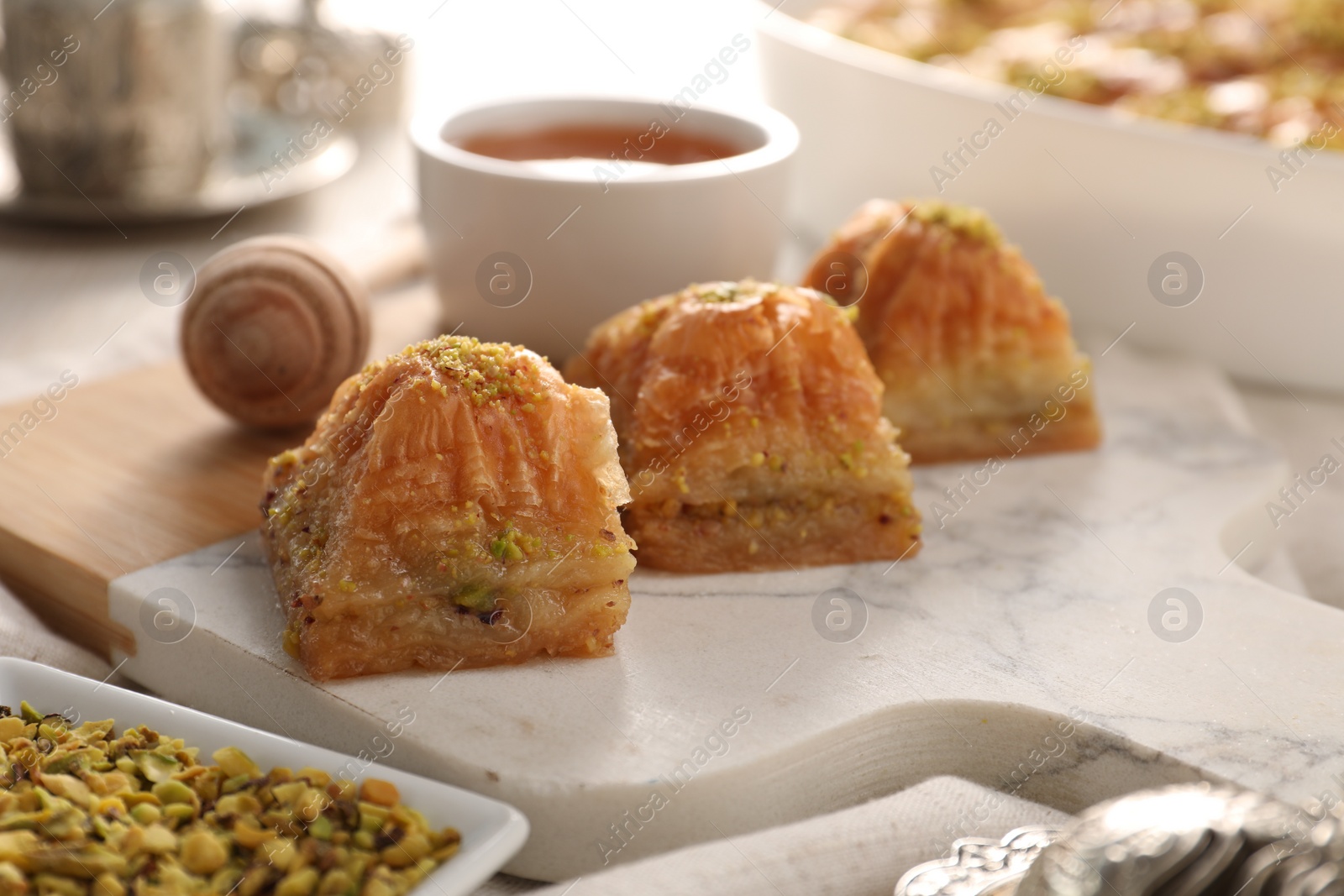 Photo of Delicious sweet baklava with pistachios on table, closeup