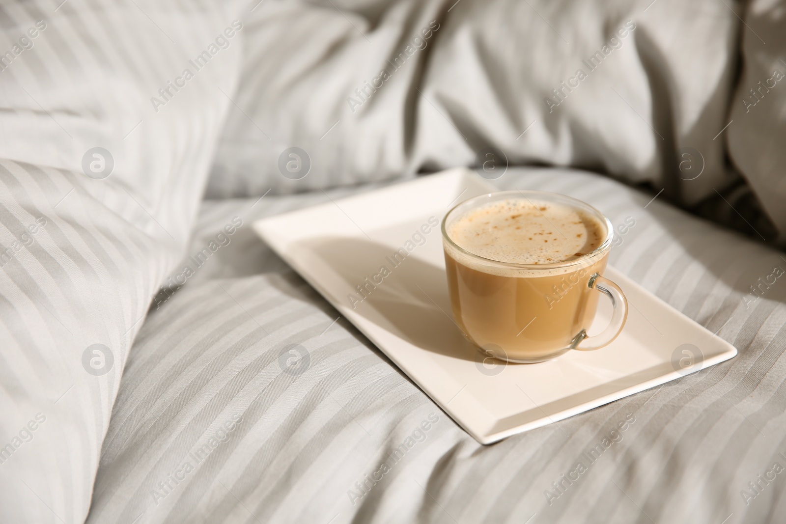 Photo of Tray with morning coffee on soft blanket. Space for text