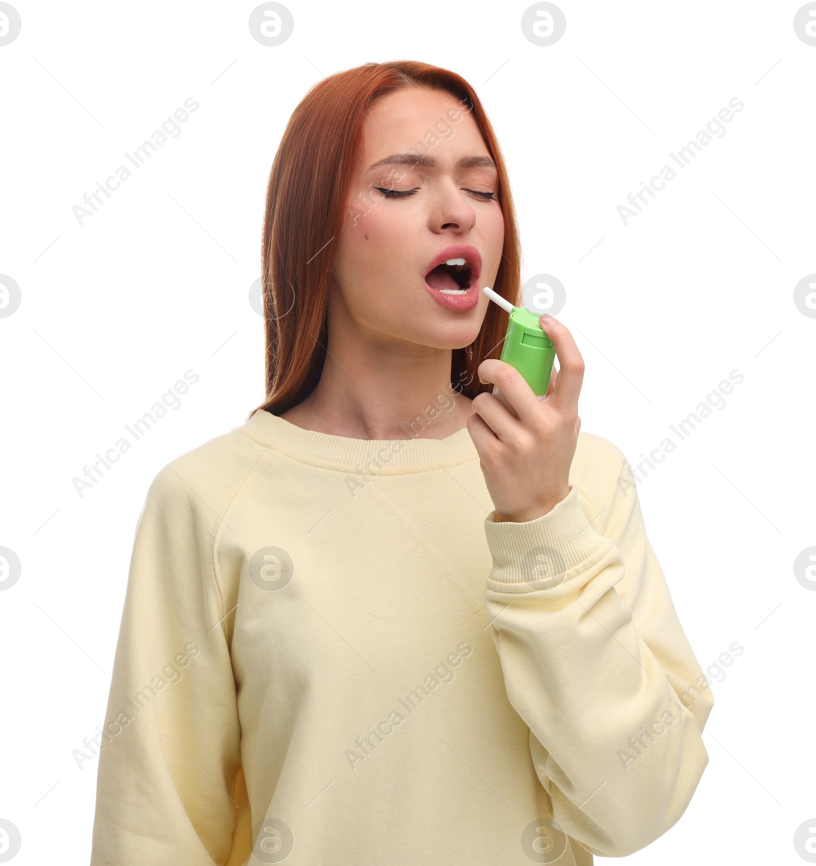 Photo of Young woman using throat spray on white background