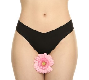 Photo of Gynecology. Woman in underwear with gerbera flower on white background, closeup