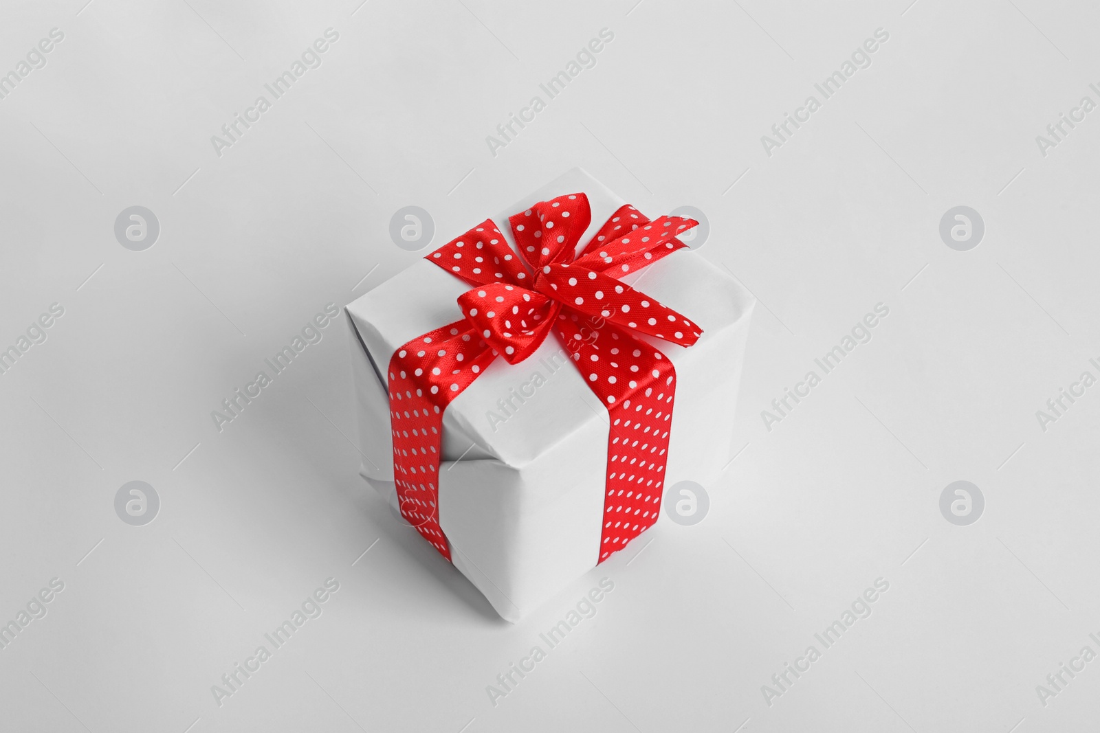 Photo of Beautifully wrapped gift box on white background