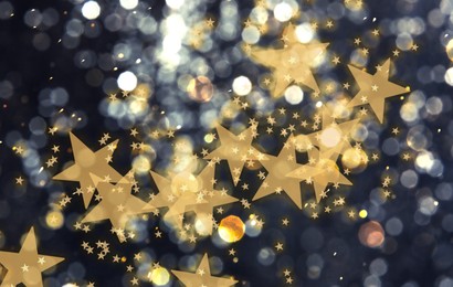 Image of Festive background with many beautiful shimmering stars and blurred lights. Bokeh effect