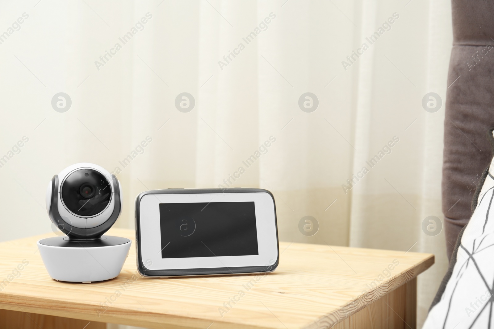 Photo of Baby monitor with camera on table in room, space for text. Video nanny