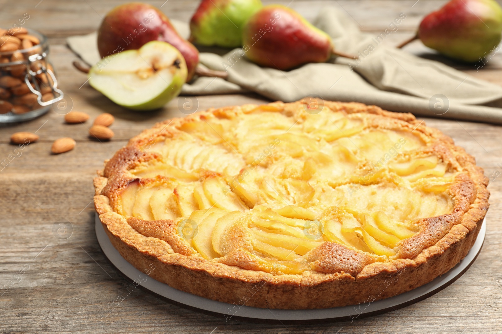 Photo of Delicious sweet pear tart on wooden table