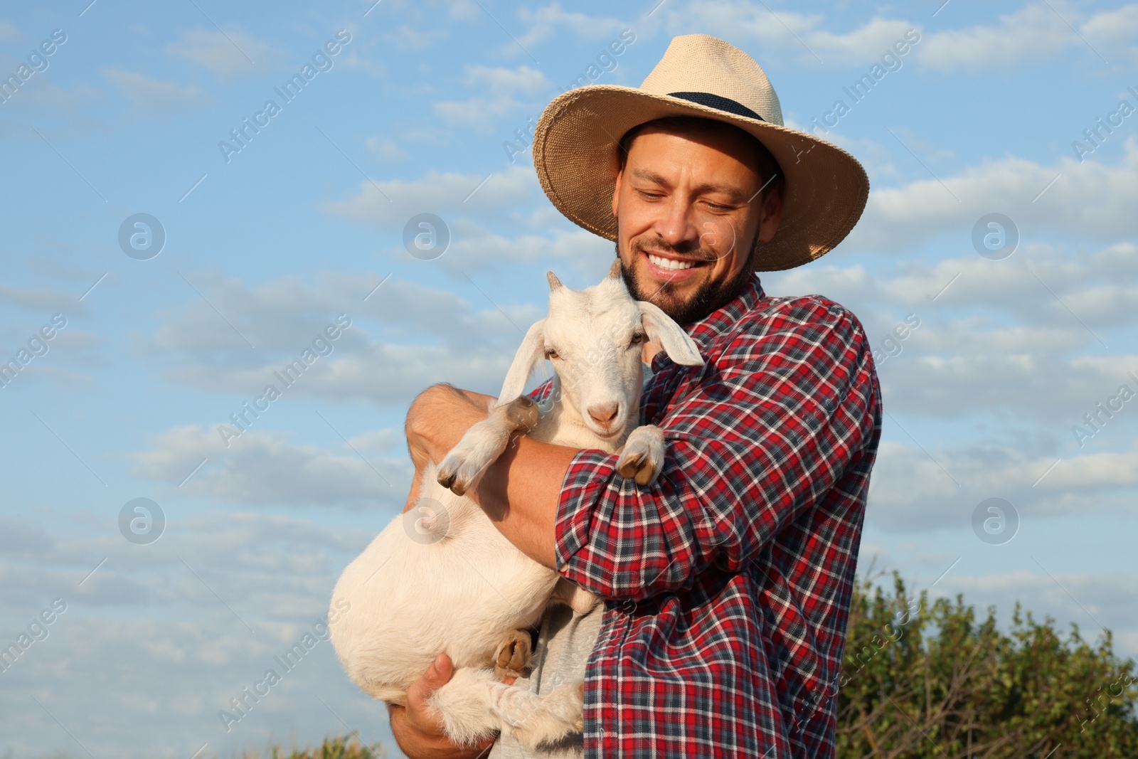 Photo of Man with goat at farm. Animal husbandry