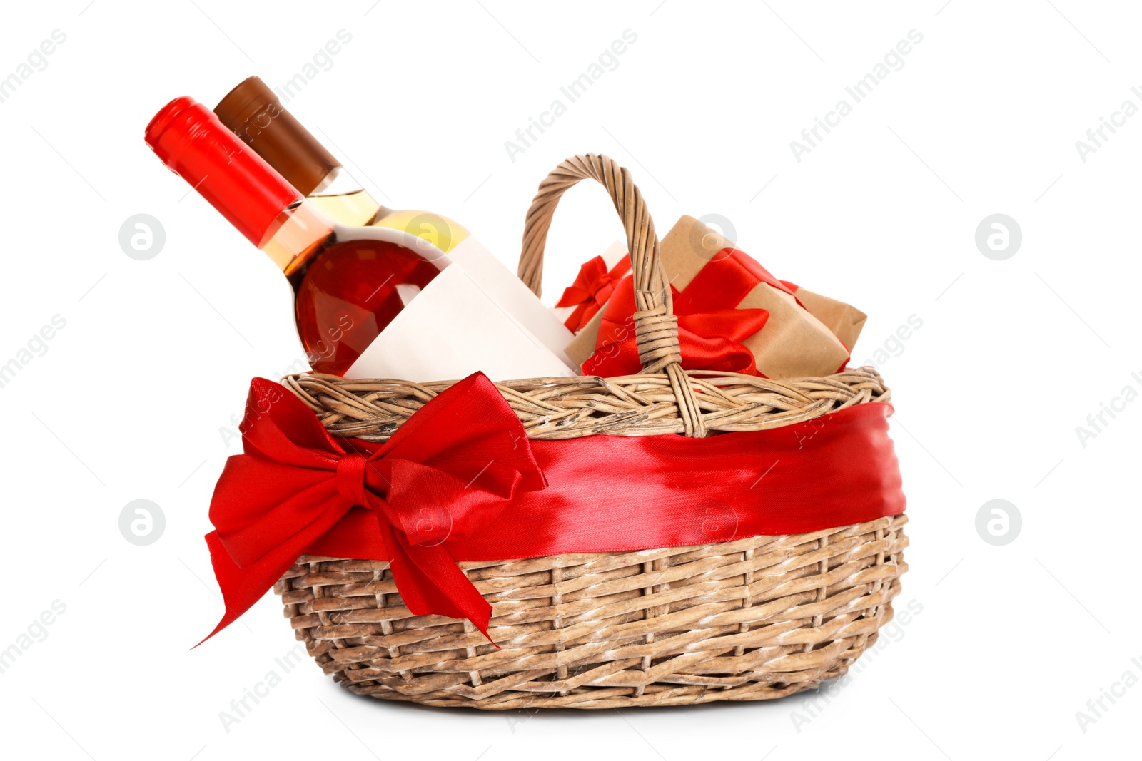 Photo of Festive basket with bottles of wine and gifts on white background