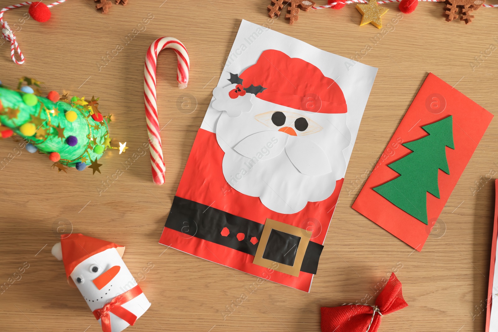 Photo of Flat lay composition with Christmas greeting cards on wooden table