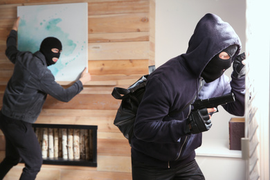 Dangerous masked criminals stealing picture from house