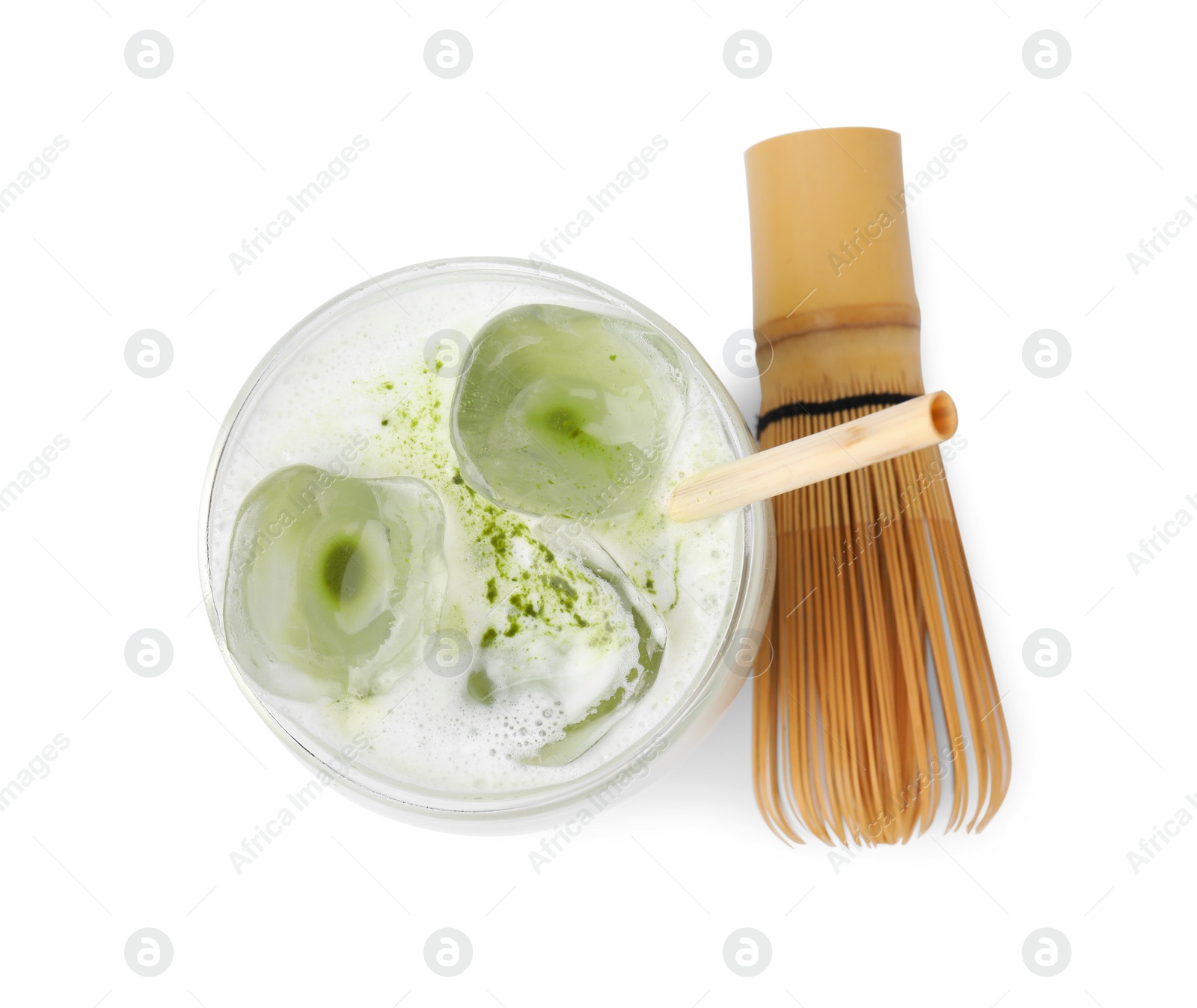 Photo of Glass of tasty iced matcha latte and bamboo whisk isolated on white, top view