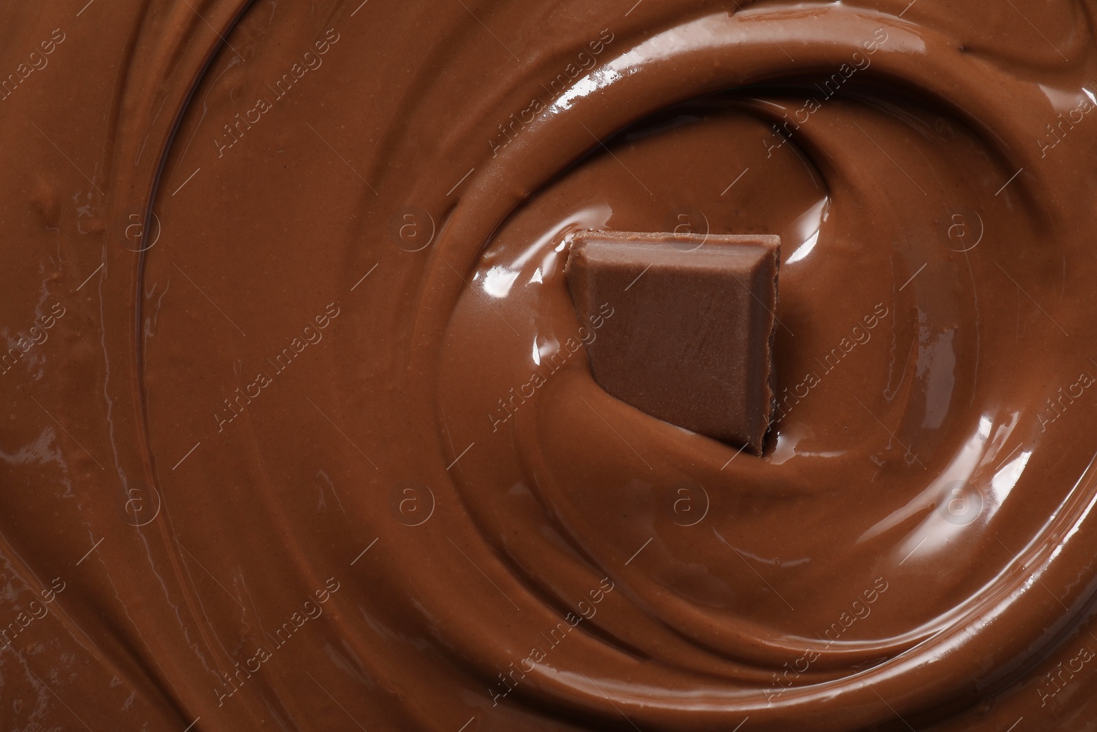 Photo of Tasty milk chocolate paste and piece as background, top view
