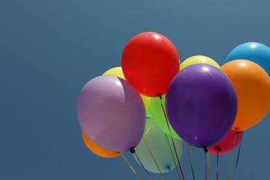 Bunch of colorful balloons against blue sky