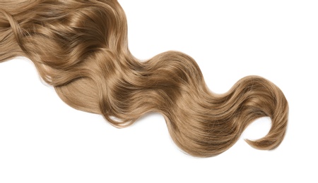 Photo of Lock of brown wavy hair on white background, top view