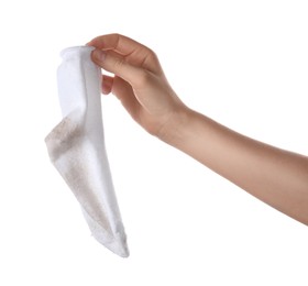 Woman holding dirty sock on white background, closeup
