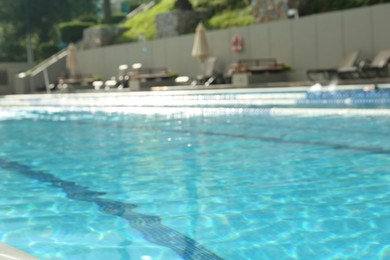 Photo of Blurred view of outdoor swimming pool with clear rippled water