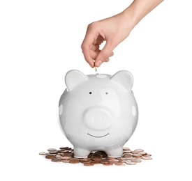 Woman putting coin into piggy bank on white background, closeup