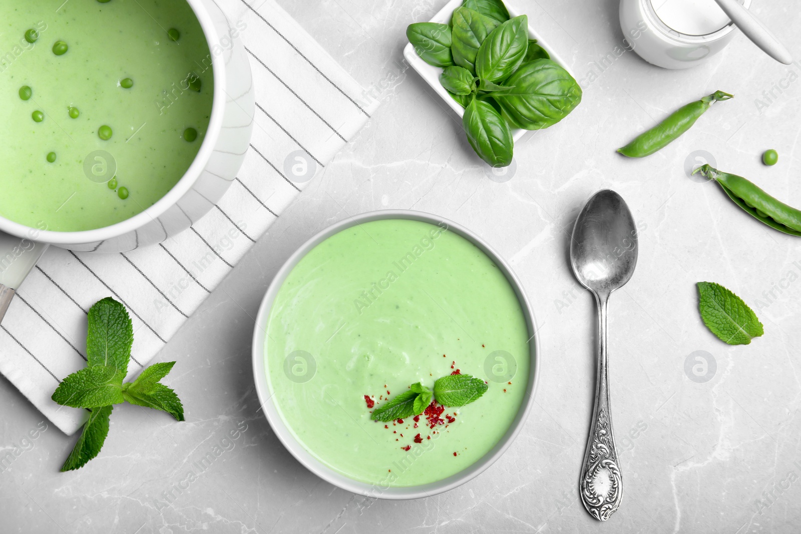 Photo of Flat lay composition with green pea soup on grey background