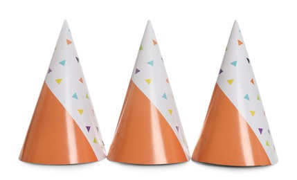 Bright birthday party hats on white background