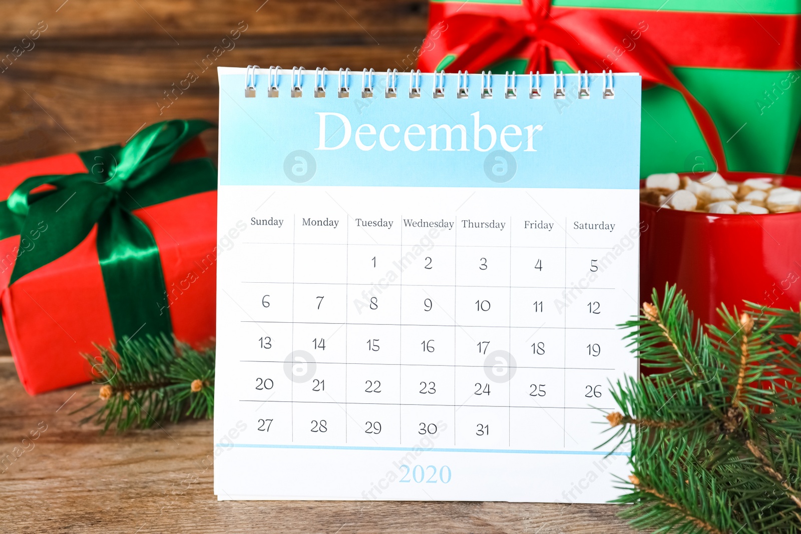 Photo of Flip calendar and Christmas decor on wooden table. Holiday countdown