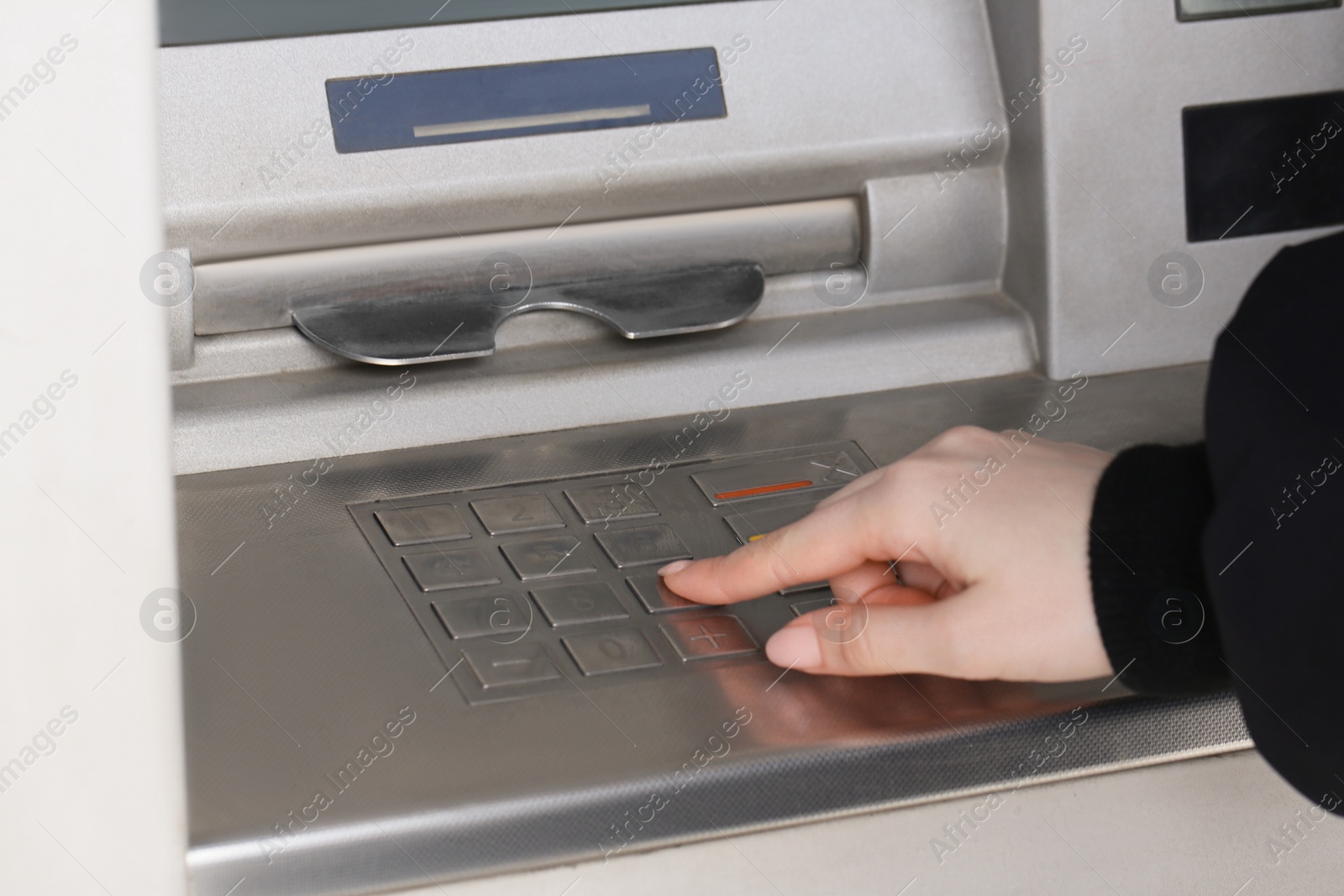 Photo of Woman using modern grey cash machine, closeup