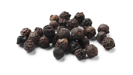 Aromatic spice. Many black dry peppercorns isolated on white