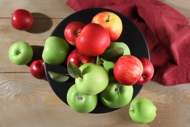 Fresh ripe red and green apples on wooden table, flat lay