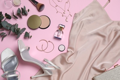 Flat lay composition with elegant beige dress and women's accessories on pink background