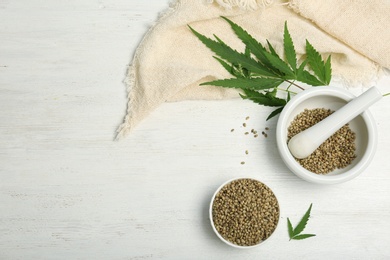 Photo of Flat lay composition with hemp seeds and space for text on wooden background