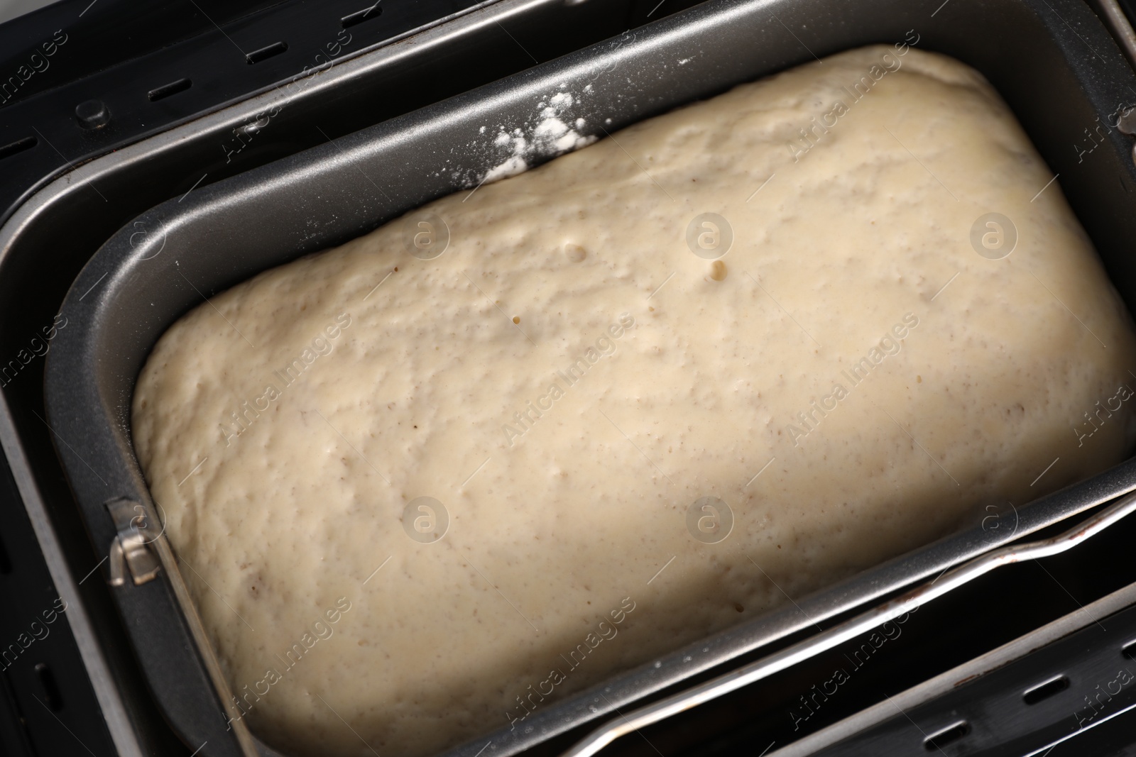 Photo of Modern bread maker with raw dough, above view