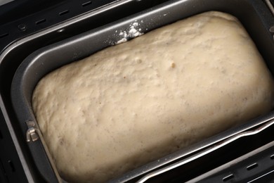 Photo of Modern bread maker with raw dough, above view