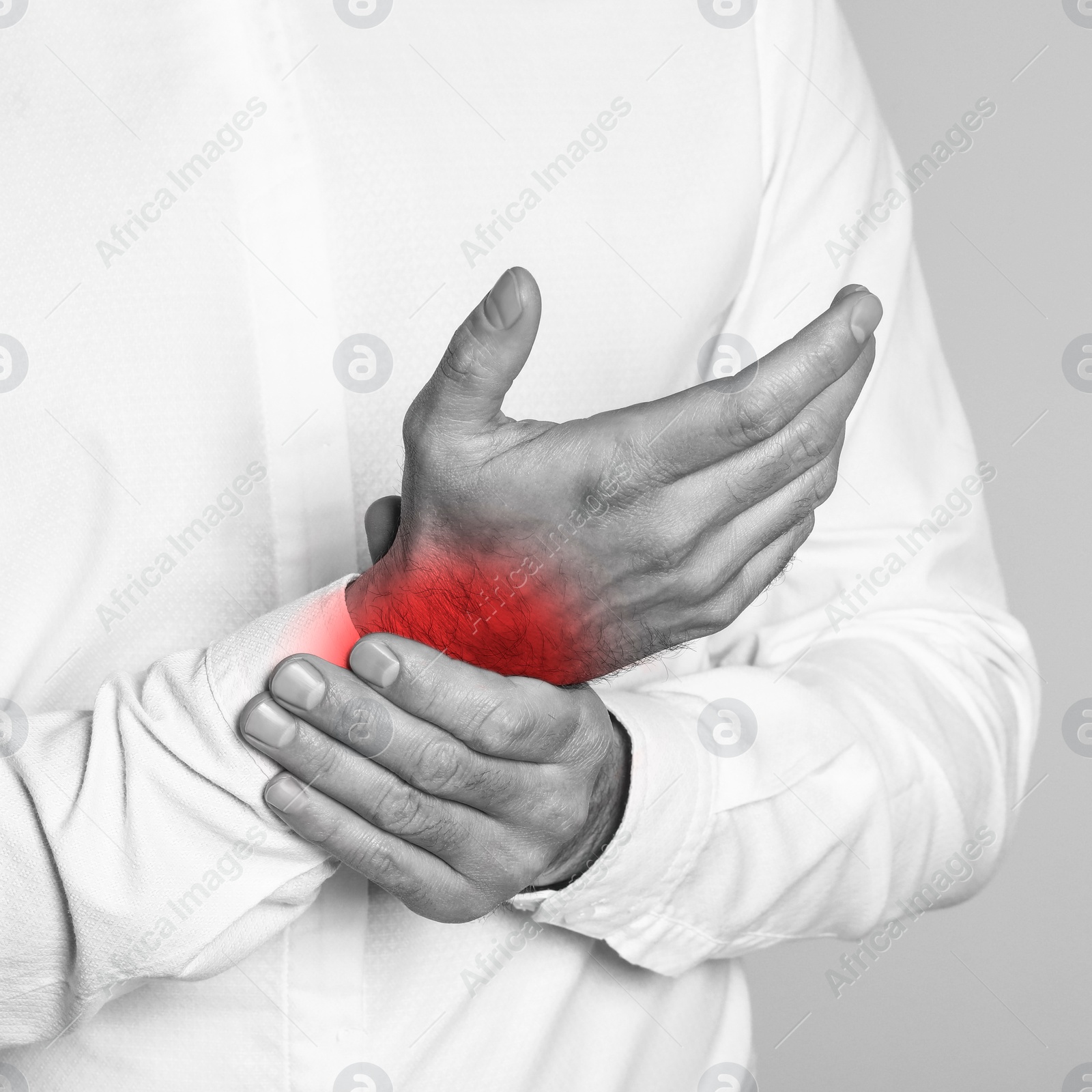 Image of Man suffering from rheumatism, closeup. Black and white effect with red accent in painful area