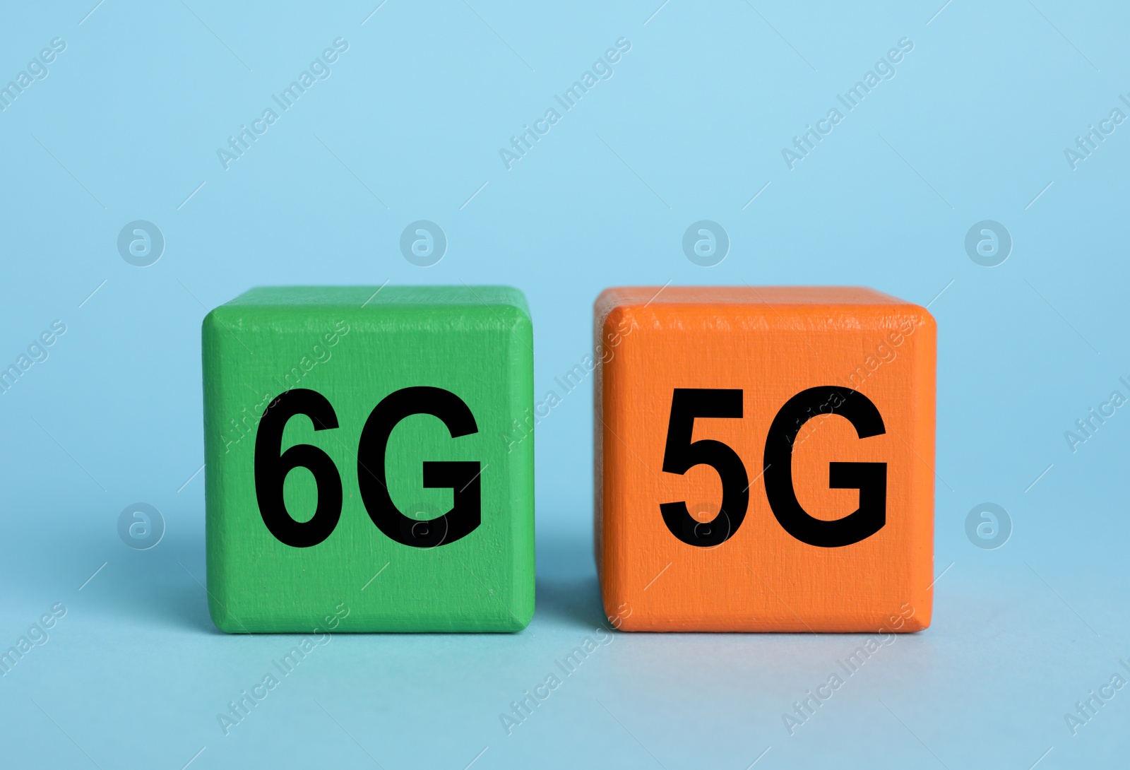 Photo of Cubes with 6G and 5G symbols on light blue background