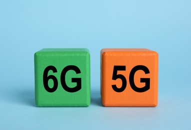 Photo of Cubes with 6G and 5G symbols on light blue background