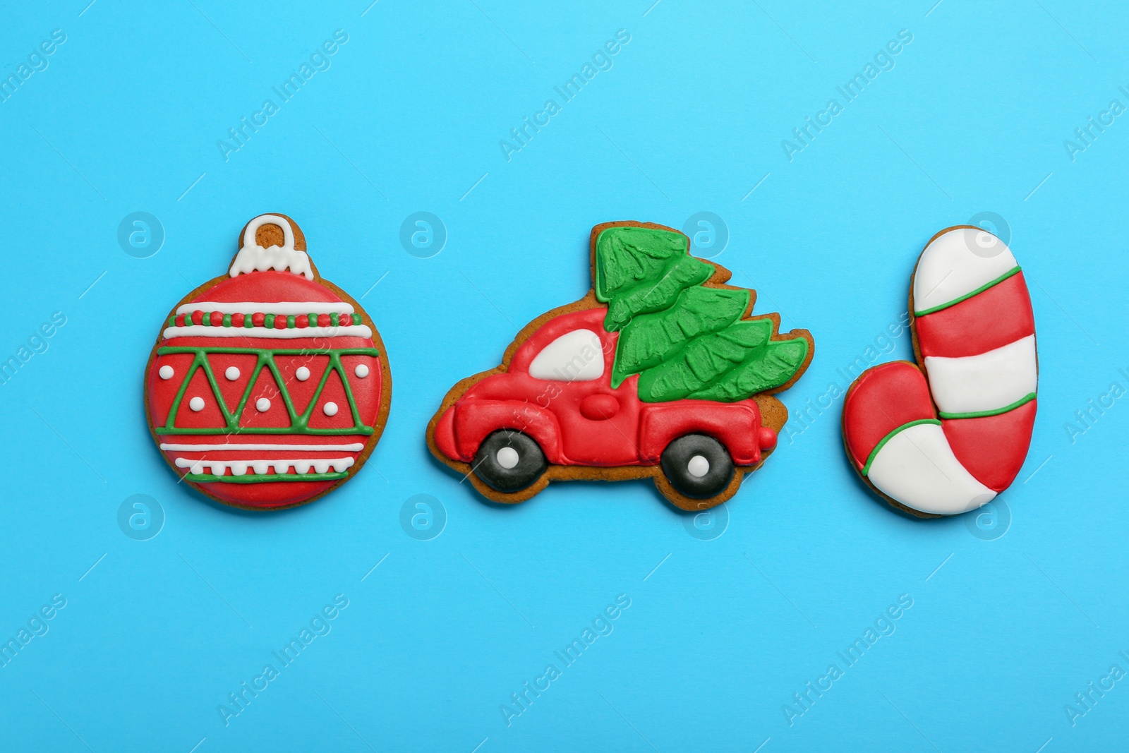 Photo of Different tasty Christmas cookies on light blue background, flat lay