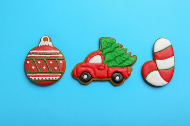 Different tasty Christmas cookies on light blue background, flat lay