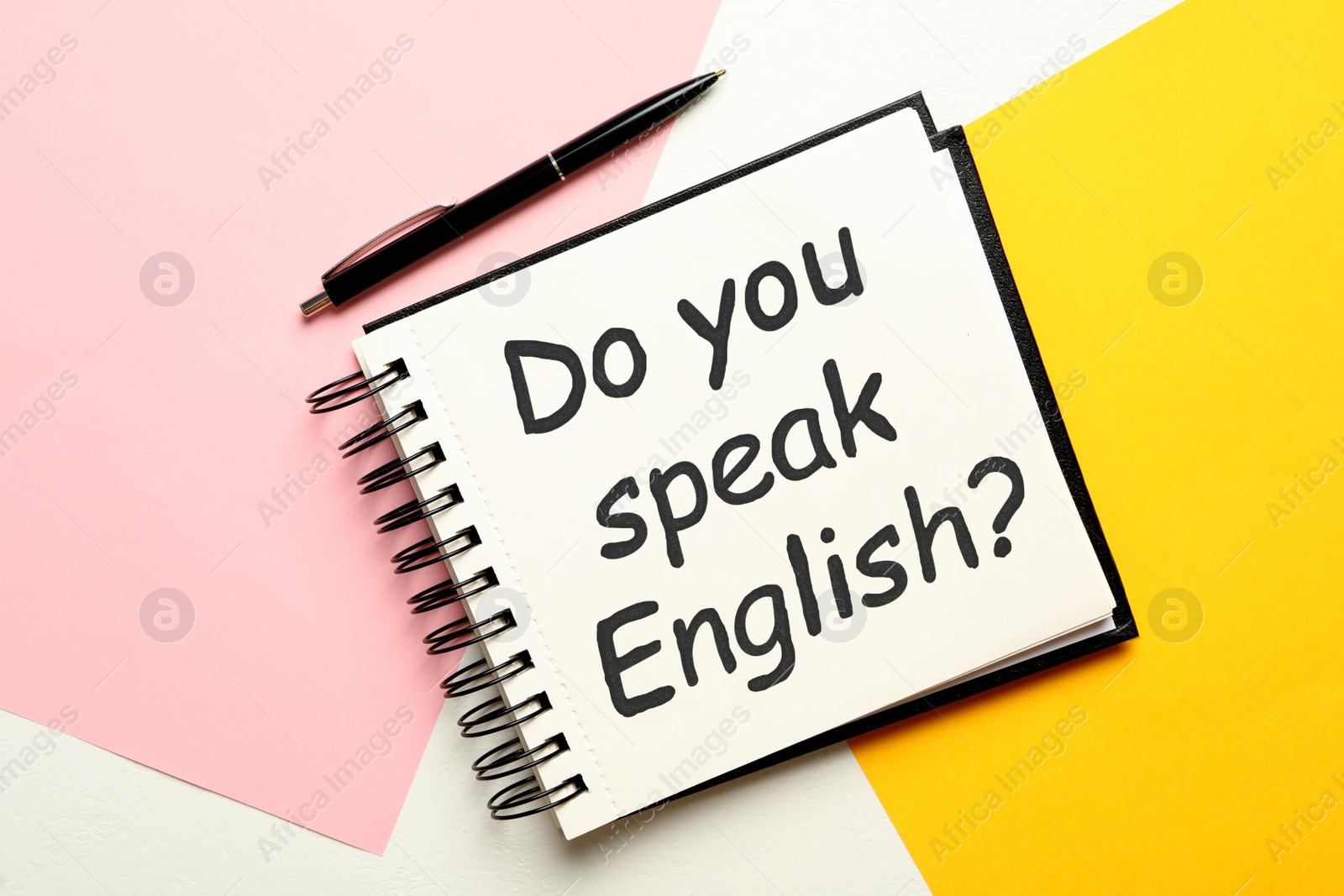 Photo of Notepad with question Do You Speak English and pen on color background, flat lay