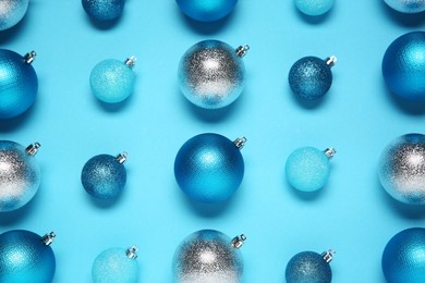 Photo of Christmas balls on light blue background, flat lay