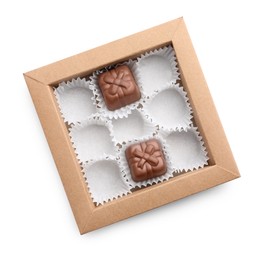 Photo of Partially empty box of chocolate candies isolated on white, top view