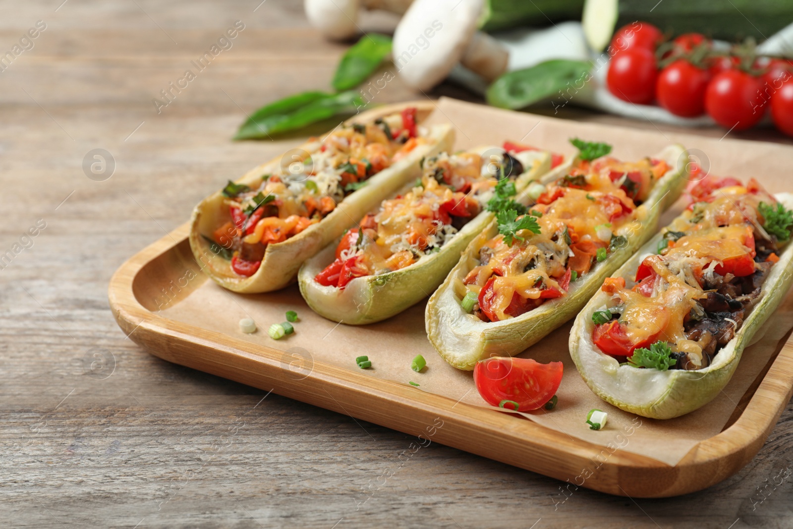 Photo of Delicious stuffed zucchini served on wooden table