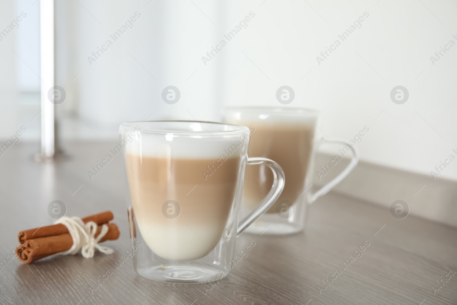 Photo of Delicious latte macchiato on wooden table indoors