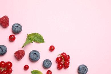 Photo of Mix of fresh berries on pink background, flat lay. Space for text