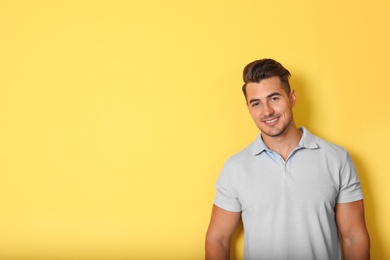 Portrait of handsome young man and space for text on color background